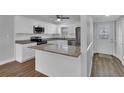 Renovated kitchen with granite counters and stainless steel appliances at 2351 Irish Ln # 21, Clearwater, FL 33763