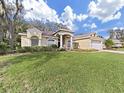Landscaped yard and attractive curb appeal with a two-car garage at 3307 Kilmer Pl, Plant City, FL 33566