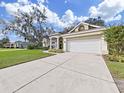 House exterior showcasing a two-car garage and well-maintained lawn at 3307 Kilmer Pl, Plant City, FL 33566