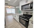 Modern kitchen featuring stainless steel appliances and granite countertops at 3546 Cheswick Dr, Holiday, FL 34691