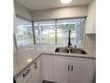 Kitchen with granite countertops and a view of the backyard at 3546 Cheswick Dr, Holiday, FL 34691