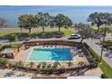 Community pool with brick border and ample seating at 4015 Bayshore Blvd # 9D, Tampa, FL 33611