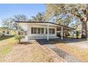 Front view of a single story home with carport at 4711 Olive Dr, Zephyrhills, FL 33542