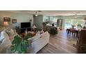 Open living area with hardwood floors, updated kitchen, and pool view at 5730 16Th Ne Ln, St Petersburg, FL 33703