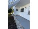 Exterior view of condo building, showing walkway, landscaping, and building exterior at 5895 18Th N St # 9, St Petersburg, FL 33714
