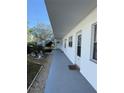 Exterior view showing condo building with walkway and landscaping at 5895 18Th N St # 9, St Petersburg, FL 33714