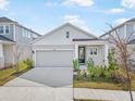 Charming one-story house with gray siding, white accents, and a two-car garage at 5936 Golden Nettle Dr, Apollo Beach, FL 33572