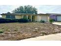 House exterior showcasing a spacious yard at 7614 Karen Dr, Port Richey, FL 34668