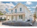 Two-story home boasts large windows and a covered front porch with columns, showcasing its classic design at 870 29Th N Ave, St Petersburg, FL 33704