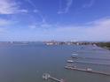 Aerial view of waterfront homes with boat slips and city skyline in background at 100 Bluff View Dr # 401A, Belleair Bluffs, FL 33770