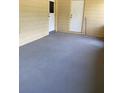 Small back patio with concrete flooring and two doors at 1001 E 26Th Ave, Tampa, FL 33605