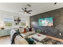 Bright living room with large windows, stylish sofa, modern wall art, and contemporary decor at 10144 Arbor Run Dr # 107, Tampa, FL 33647