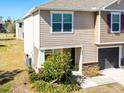 Two-story tan house with a small front yard and shrubs at 10428 Rivercrest Dr, Riverview, FL 33578