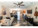 Open living room with dark marble floors and a comfy sofa at 10428 Rivercrest Dr, Riverview, FL 33578