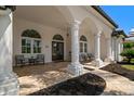 Covered porch with arched entry, columns, and tile flooring at 1257 Kings Way Ln, Tarpon Springs, FL 34688