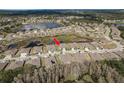 A captivating aerial view highlights the home's location, showcasing its proximity to a lake, pond and surrounding neighborhood at 13387 Crest Lake Dr, Hudson, FL 34669