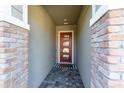 Brick entryway with a modern glass and wood front door at 14015 Kingfisher Glen Dr, Lithia, FL 33547