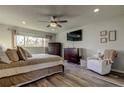 Comfortable main bedroom with warm lighting, modern furniture, wood flooring, and a large window at 2284 Philippine Dr # 71, Clearwater, FL 33763