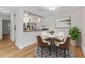 Bright dining area with a table for four and open kitchen access at 304 S Habana Ave # A3, Tampa, FL 33609