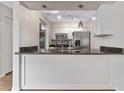 Modern kitchen with stainless steel appliances and granite countertops at 304 S Habana Ave # A3, Tampa, FL 33609