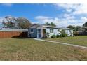 Light blue one-story house with a landscaped yard and carport at 3046 35Th N Ave, St Petersburg, FL 33713