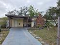 Ranch-style home with carport and brick chimney at 4002 W Gray St, Tampa, FL 33609