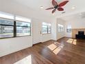 Sunlit living room boasts hardwood floors, large windows, and recessed lighting at 4219 4Th S Ave, St Petersburg, FL 33711