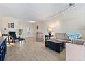 Bright living room with tile floors, comfy seating, and a view to the dining area at 5095 Bay Ne St # 117, St Petersburg, FL 33703