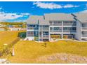 Back view of condo showing balcony and grassy area at 828 Bahia Del Sol Dr # 59/ A, Ruskin, FL 33570