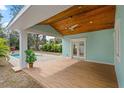 Covered patio with wood ceiling and access to the backyard and pool at 1061 Sedeeva St, Clearwater, FL 33755