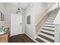 Bright entryway with wood floors, stairs, and a view of the front door at 12408 Victarra Pl, New Port Richey, FL 34655