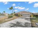 Front view of a single story house with a paved driveway at 1311 Caloosa Lake Ct, Sun City Center, FL 33573