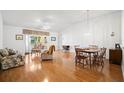 Bright living room with hardwood floors and a dining area at 1311 Caloosa Lake Ct, Sun City Center, FL 33573