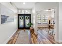 Bright foyer featuring hardwood floors, transom window, double door entry and an open office area at 15110 Shearcrest Dr, Lithia, FL 33547