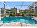 Stunning screened-in pool area featuring lush landscaping and a relaxing spa at 15110 Shearcrest Dr, Lithia, FL 33547