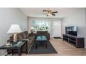 Cozy living room with neutral walls, a ceiling fan, and a large window for natural light at 1570 S Michigan Ave, Clearwater, FL 33756