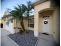 Front entrance of a house with palm trees and stone landscaping at 16103 Muirfield Dr, Odessa, FL 33556