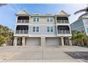 Three-story house featuring three-car garage and multiple balconies at 16317 Gulf Blvd, Redington Beach, FL 33708