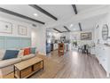 Open-concept living room with sleek wood floors, exposed beams, and seamless flow to the modern kitchen at 1707 Darlington Dr, Tampa, FL 33619