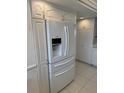 White kitchen with stainless steel refrigerator at 17900 Gulf Blvd # 16C, Redington Shores, FL 33708