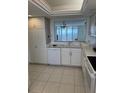 White kitchen with ocean view from window at 17900 Gulf Blvd # 16C, Redington Shores, FL 33708