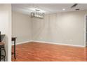 Spacious dining room with hardwood floors and modern chandelier at 1801 E Lake Rd # 15C, Palm Harbor, FL 34685