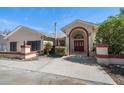 Front entrance of the house with a red door and landscape at 18419 Tyler Rd, Odessa, FL 33556