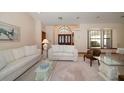 Bright living room with white sofas and a large window at 18419 Tyler Rd, Odessa, FL 33556