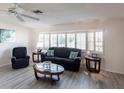 Living room with gray floors, comfy seating, and lots of natural light at 18719 Van Nuys Cir, Port Charlotte, FL 33948