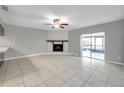 Bright living room with a fireplace and sliding glass doors leading to the patio at 3917 Briarlake Dr, Valrico, FL 33596