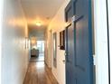 Hallway with light wood floors leading to living area at 400 Glennes Ln # 108, Dunedin, FL 34698