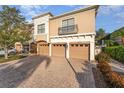 Tan three-unit building with three-car garage and paved driveway at 4079 Overture Cir # 346, Bradenton, FL 34209