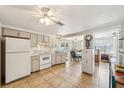 Cozy kitchen with white appliances and access to dining area at 5157 School Rd, New Port Richey, FL 34653