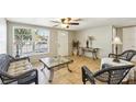 Bright living room with tiled floors and wicker furniture at 5157 School Rd, New Port Richey, FL 34653